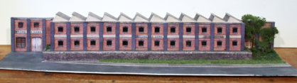 Occupying the central position, along the rear, is the factory of Wythe & Sons, in low relief.
