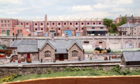 View of the station building, and factories at the rear of the layout.