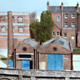 A couple of Industrial Units are complete, but their yard area needs to be furnished with clutter & workmen.