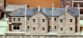 The Station Inn has drinkers inside at the bar. Again it and the attached terrace are yet to be set into their surroundings.