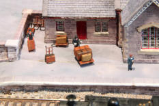 Part of the platform with porters and luggage.